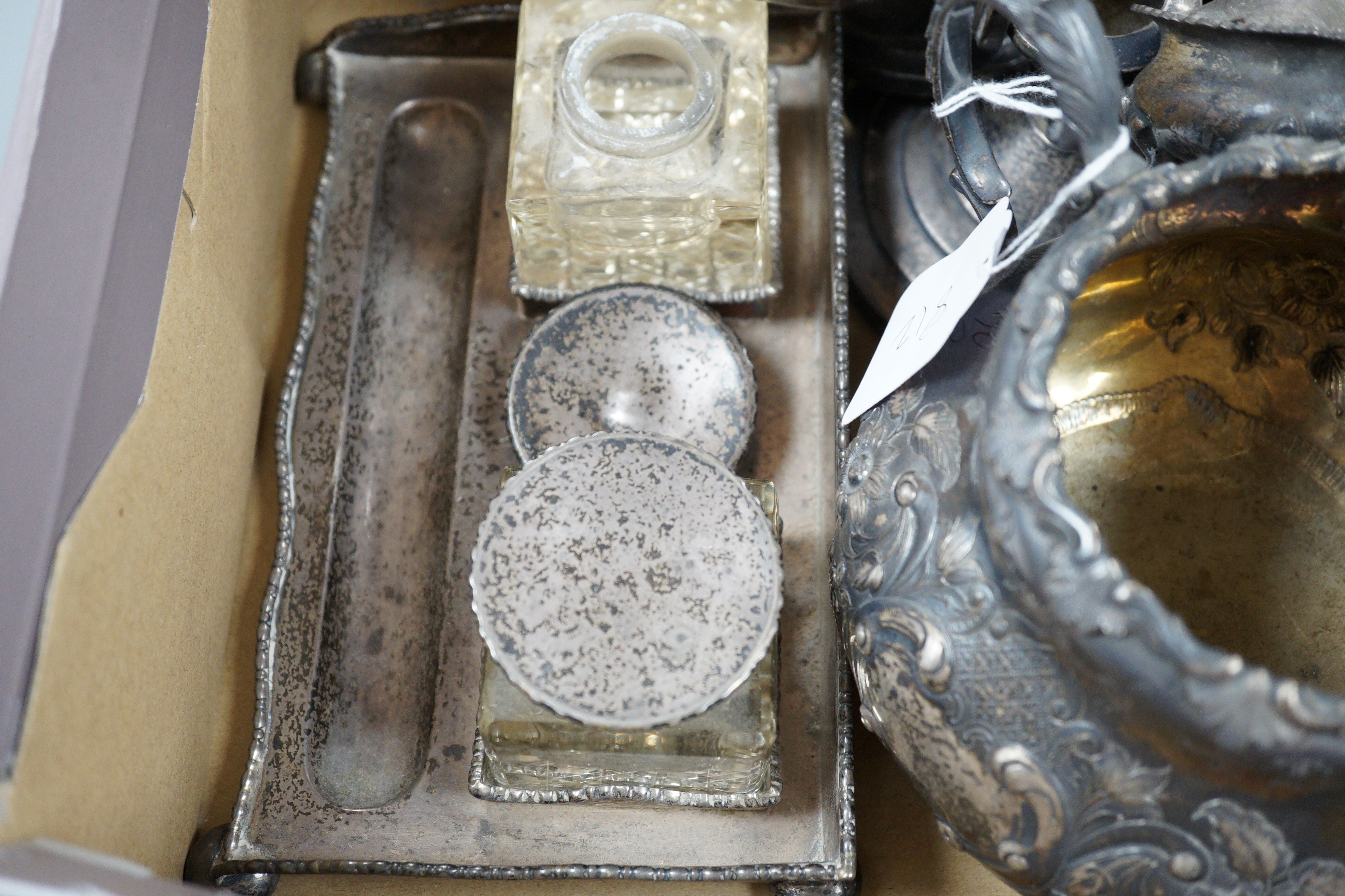 Assorted silver wares to include a George V toast rack, Birmingham, 1934, napkins rings, weighted dwarf candlesticks, cigarette case, condiments, an Edwardian desk stand and a Victorian Irish two handled sugar bowl jar,